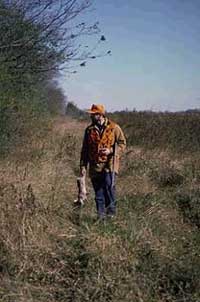 Rabbit hunter in the field with rabbit