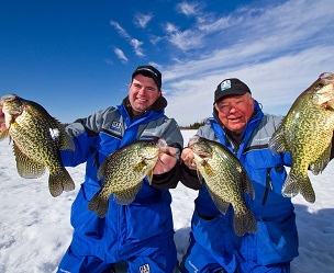 Two ice anglers holding up the crappie the caught