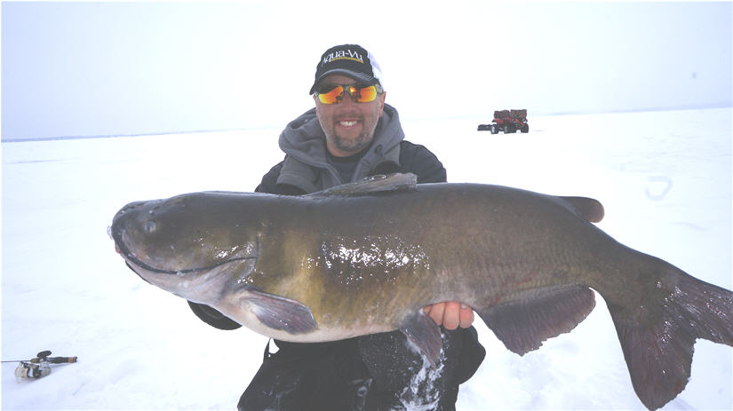 Eric Haataja holding catfish while ice fishing