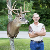 Hunter standing next to his deer mount