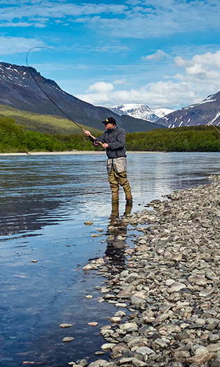 Fly Fisherman Casting in the Mountains