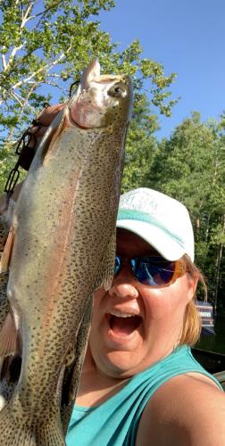 Lady angler holding up a large trout