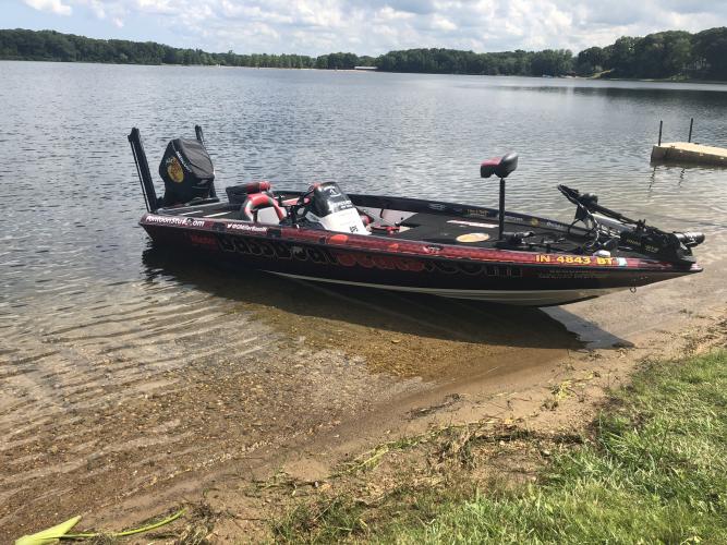 Bass boat on the bank of a lake