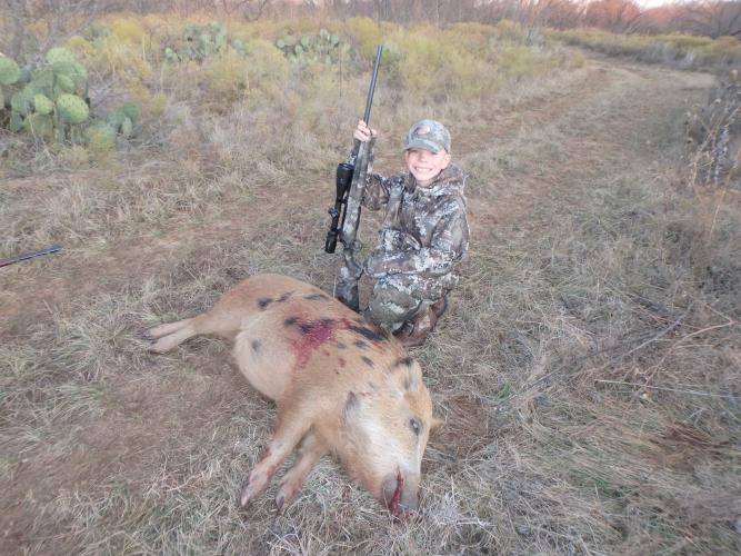 Young boy is a proud Hog Hunter