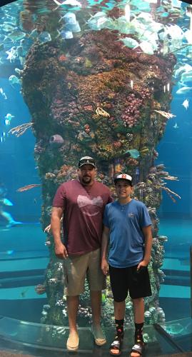 Father and son at aquarium