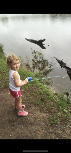 Young girl fishing at waters edge