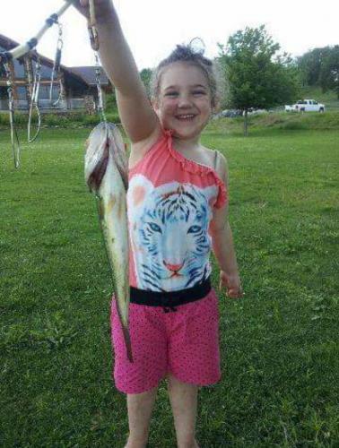 Hannah's First Catch. She's holding a bass