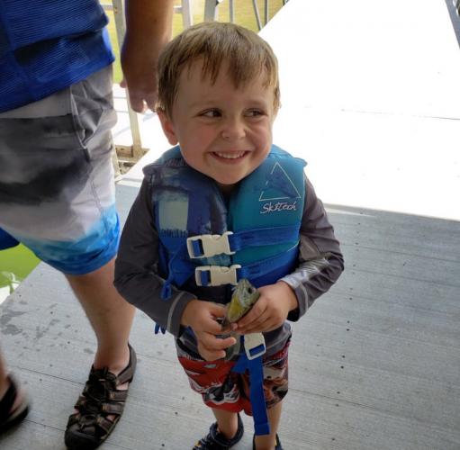 Small angler holding a perch