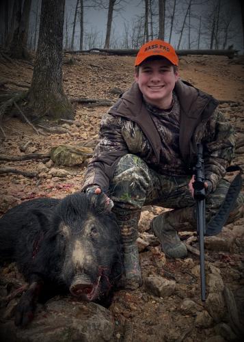 Wild pig hunter with wild pig he shot
