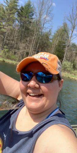 Lady angler taking a selfie with a trout