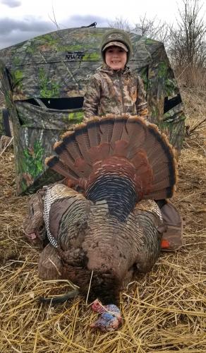 Young boy turkey hunter with turkey