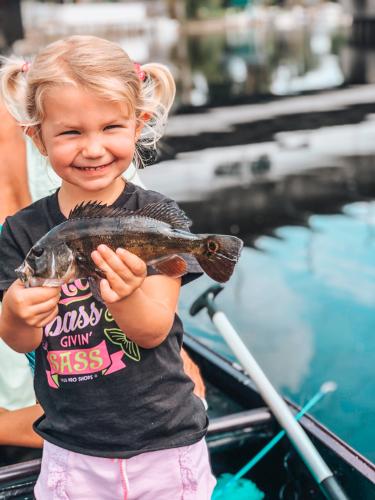 Young girl holding up her fish