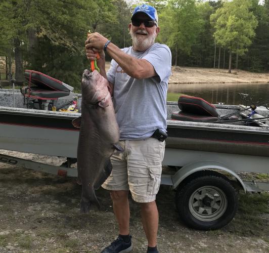 Angler with a larg blule catfish