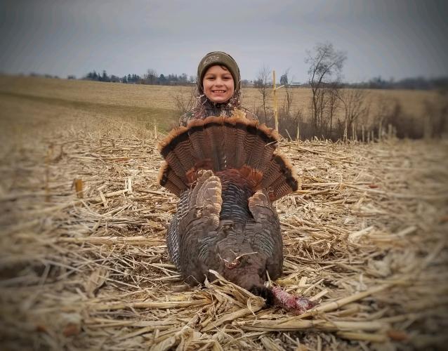 Proud young turkey hunter with his harvest