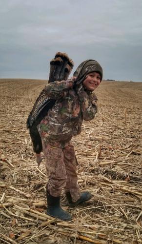 Young turkey hunter in harvested field