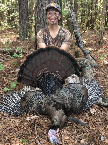 Lady turkey hunter with her turkey