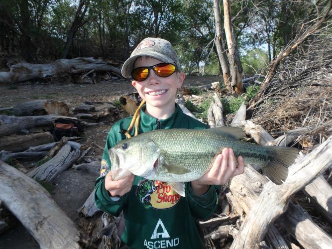 Young angler with a largemouth bass
