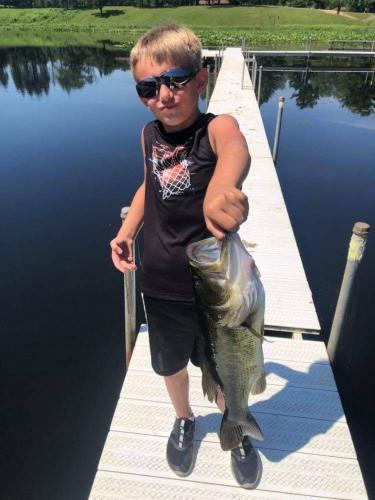 Boy holding largemouth bass