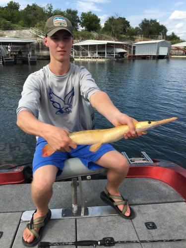 Angler holding longnose Gar