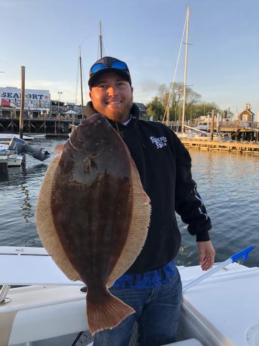 Angler hold up flounder
