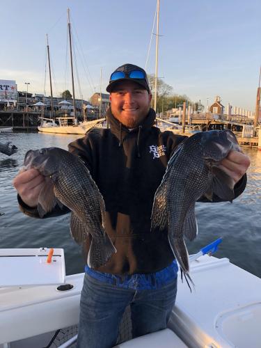 Angler holding two fish