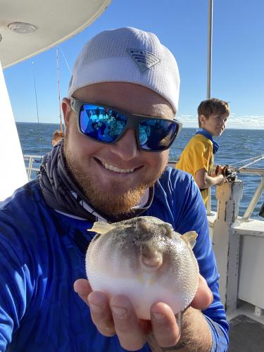 Angler holding pufferfish