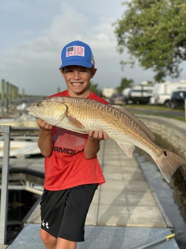 boy holding redfish