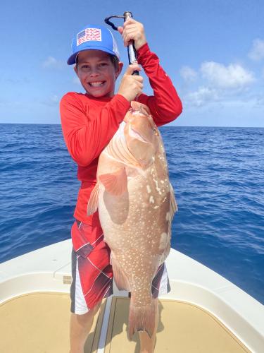 boy holding grouper