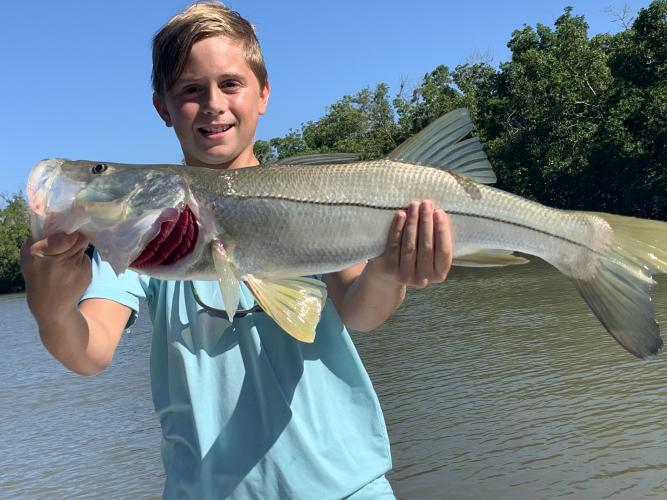 boy holding snook