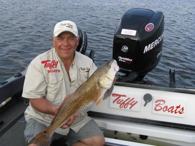 Fishing Pro Tony Puccio Holding a Nice Red Fish Braggin' Board Photo: Fishing Pro Tony Puccio Holding a Nice Red Fish
