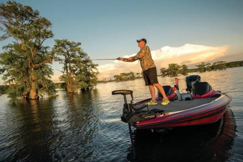 Angler fishing while trolling his fishing boat 