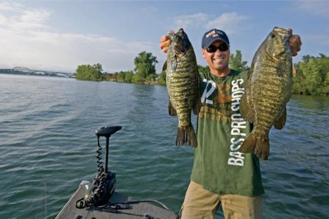 Angler holding two bass