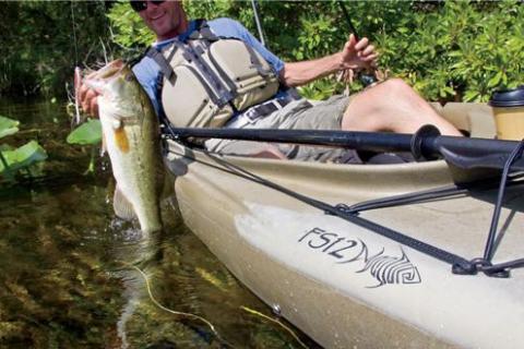 Kayak angler with a bass