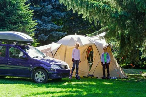 Family setting up camp with tent