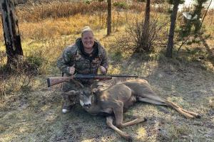 Proud lady hunter with her first buck