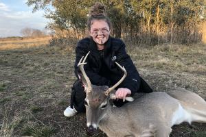 Young girl hunter with her first deer harvest