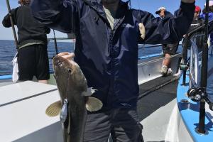 Saltwater angler holding a large saltwater fish