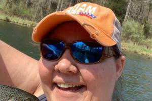 Lady angler taking a selfie with a trout