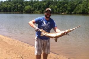 angler holding Longnose gar