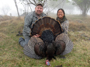Two turkey hunters holding a bird they shot