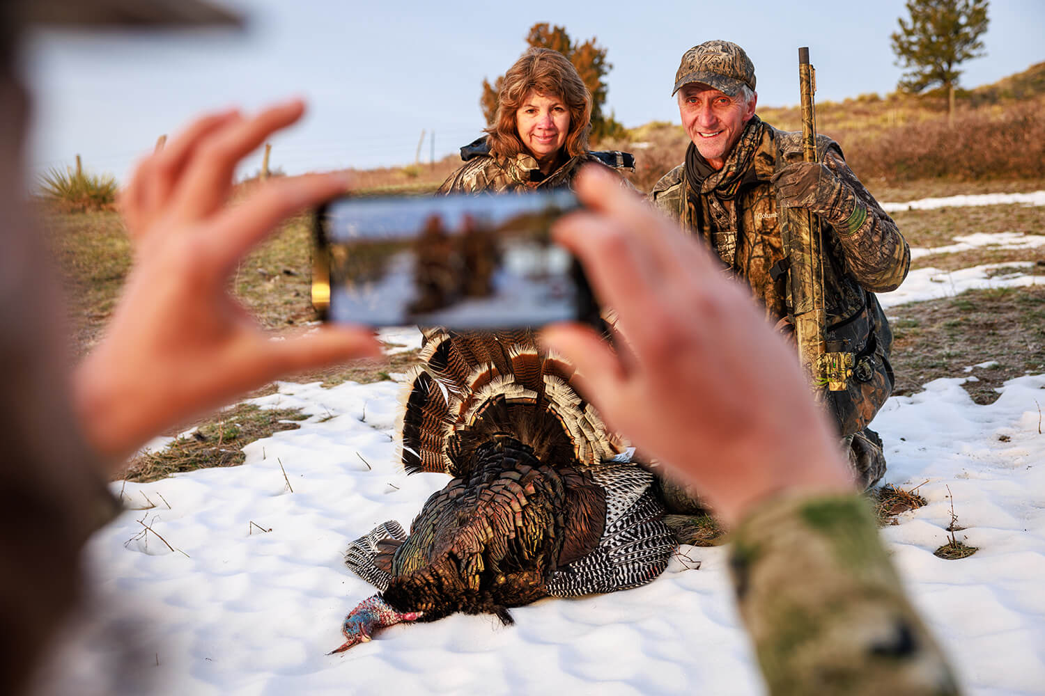 Two hunters pose for photo after successful turkey hunt