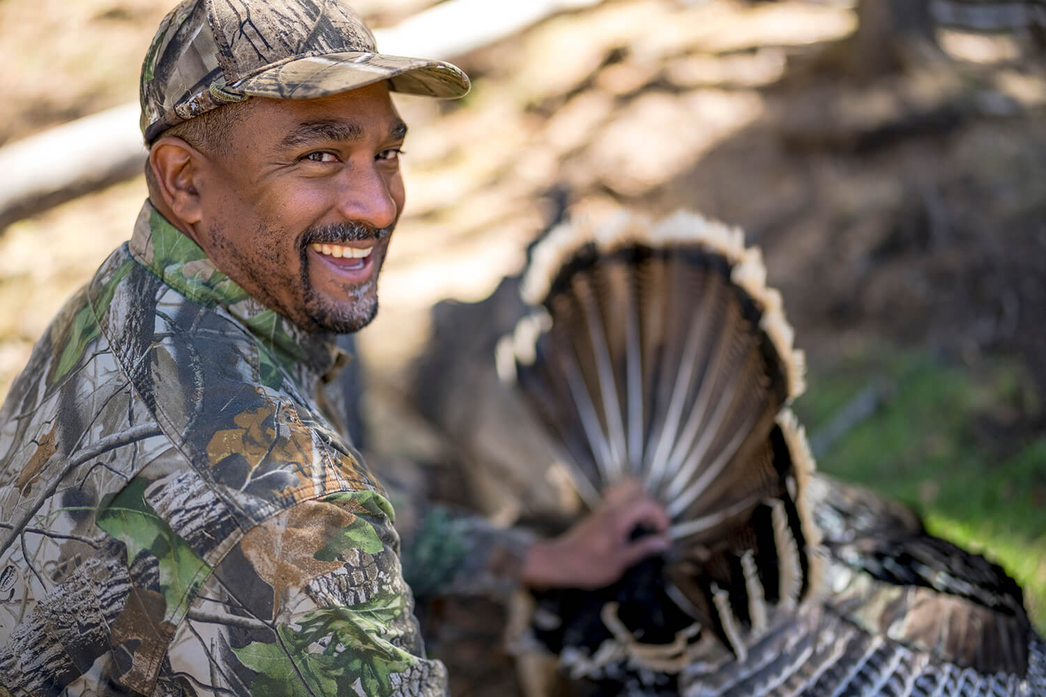 Hunter poses with turkey after hunt