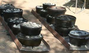 Dutch Ovens Lined Up for Cooking 