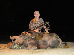 Lady hunter with the large hog she harvested