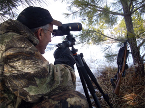Hunter using a spotting scope 