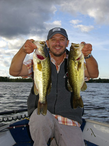 Angler holding two bass