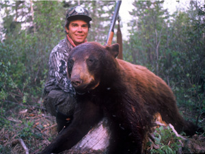 Hunter with bagged black bear