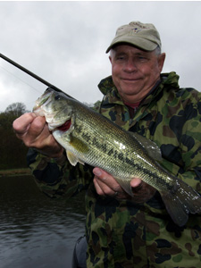 Fisher holding a bass