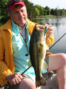 Angler & bass with topwater lure