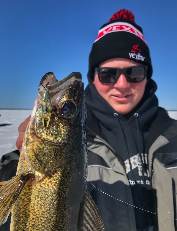 Ice angler with walleye